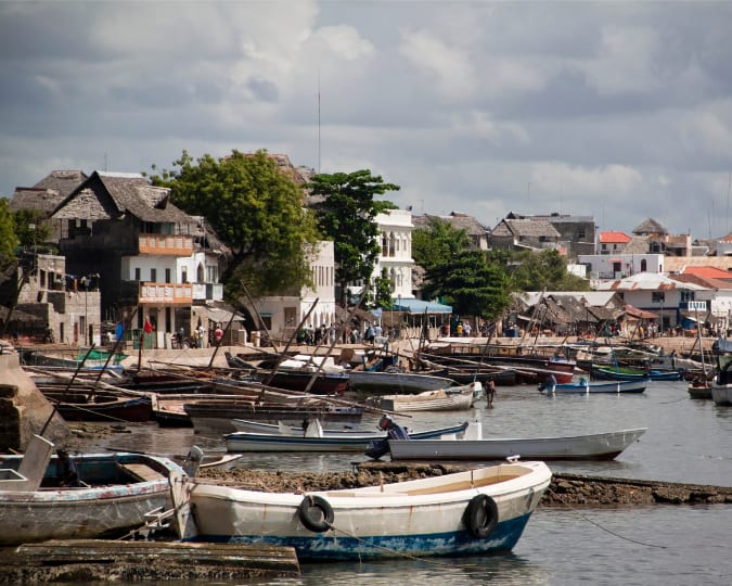 Lamu Town seafront with countless boats lined up against the sea wall