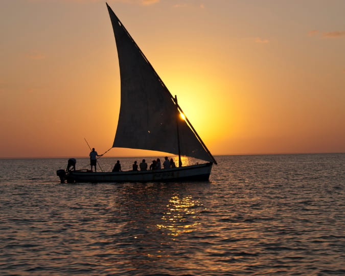 A dhow sailing on the Indian Ocean at sunset
